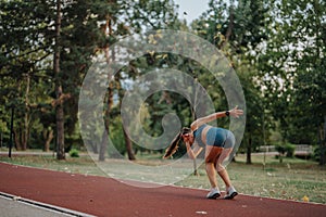 Fit and flexible female athlete inspire with 360 degree cartwheels and flips in an evening park training session.