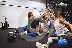 Fit friends high fiving together after a gym class