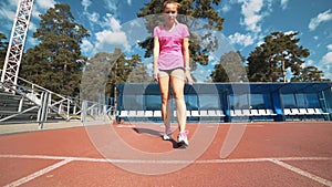 Fit girl in activewear standing at start line