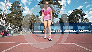 Fit girl in activewear standing at start line