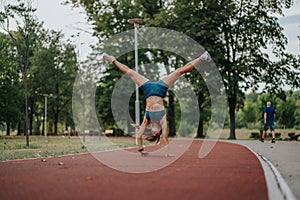 Fit girl in a green park perform impressive 360 degree cartwheels and flips, showcasing their athleticism, flexibility