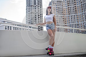 Fit girl in jeans shorts and in roller-skates looking good