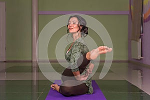 Fit girl performing yoga asana in fitness class