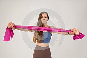 fit girl training body with resistance band  on white