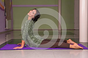 Fit girl working out by stretching in yoga