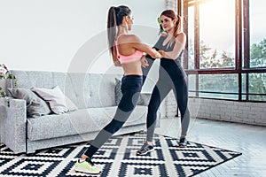 Fit girls preparing legs workout. Leg stretching exercise fitness woman doing warm-up, hamstring muscles stretch