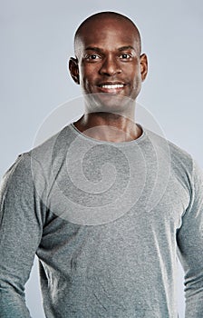 Fit handsome smiling man in gray shirt