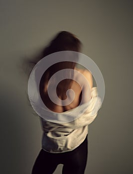 Fit healthy body woman dancing in white shirt and back. Fitness class. Athletic lady performing movements on studio