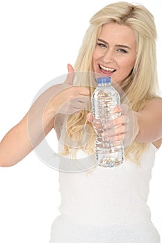 Fit Healthy Positive Young Blonde Woman Holding a Bottle of Mineral Water