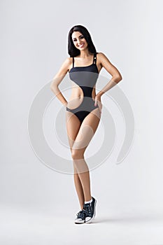 Fit, healthy and sporty girl in swimsuit. Sport, fitness, diet and healthcare concept.