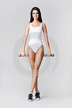 Fit, healthy and sporty girl in swimsuit. Sport, fitness, diet and healthcare concept.