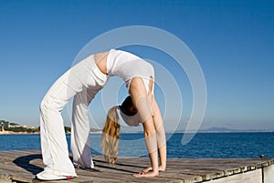 Fit healthy woman doing back bend