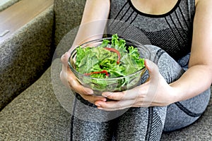 Fit healthy woman eating a fresh salad