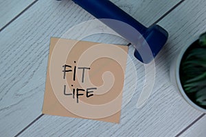 Fit Life write on sticky notes isolated on Wooden Table