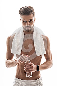 Fit male athlete drinking after exercising