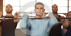 Fit Male Friends Lifting Dumbbells During Workout Session in Gym.