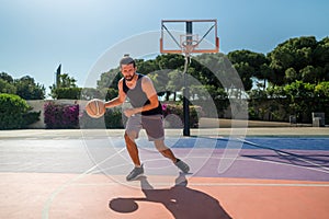 Fit male playing basketball outdoor