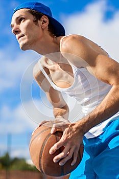 Fit male playing basketball outdoor