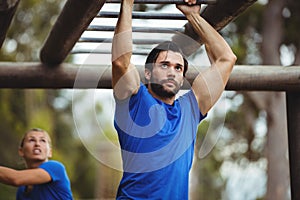 Fit man climbing monkey bars