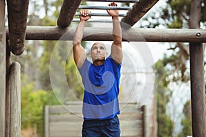 Fit man climbing monkey bars