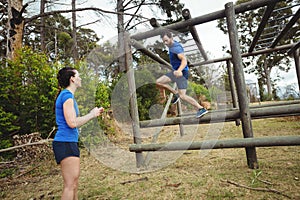 Fit man climbing monkey bars