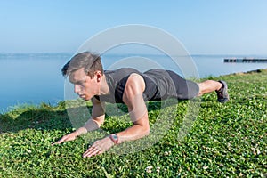 Fit man doing plank core exercise working on abdominal back muscles