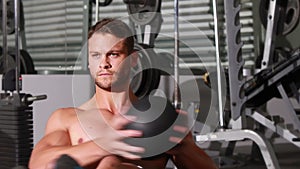 Fit man doing twist exercise at crossfit gym