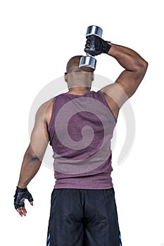 Fit man exercising with dumbbell