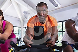 Fit man exercising on exercise bike in fitness center