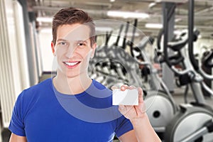 Fit man holding blank visiting card