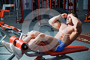 Fit man lift torso train abdominal muscles workout at gym