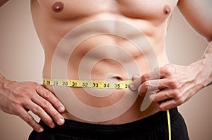 Fit Man Measuring His Waist photo