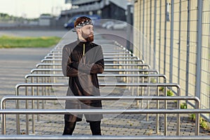 Fit man doing triceps dips on parallel bars at park exercising outdoors