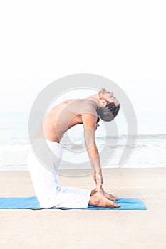 Fit man performing yoga asana