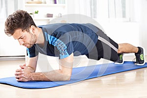 Fit Man in Planking Exercise Facing the Floor photo