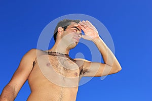 Fit man posing in a beach
