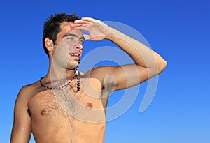 Fit man posing in a beach