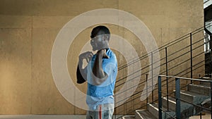 Fit man in sport clothes warming up before running on stairs