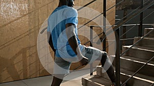 Fit man stretching legs, doing lunge exercise on stairs