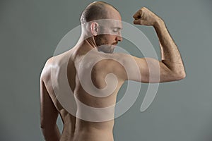 Fit man training his biceps