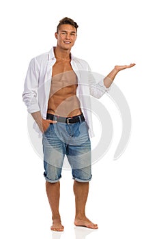 Fit Man In Unbuttoned Shirt Holding Product