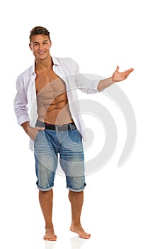 Fit Man In Unbuttoned Shirt Presenting Something