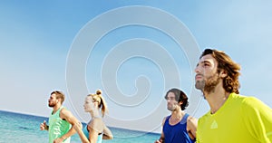 Fit man and woman jogging at beach