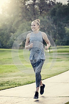 Fit middle aged woman jogging outdoors