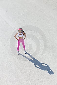 Fit middle-aged woman resting after training in park