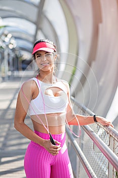 Fit middle-aged woman resting after training in park