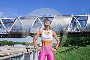 Fit middle-aged woman resting after training in park