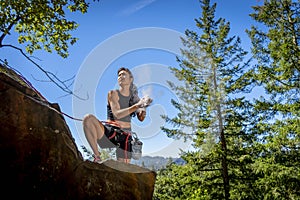 A Fit Mixed Race Female Athlete Rock Climbs In The Pacific Northwest