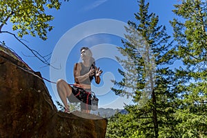 A Fit Mixed Race Female Athlete Rock Climbs In The Pacific Northwest