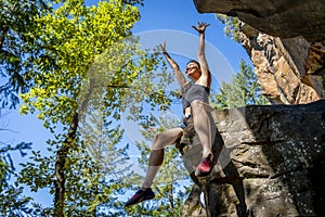 A Fit Mixed Race Female Athlete Rock Climbs In The Pacific Northwest